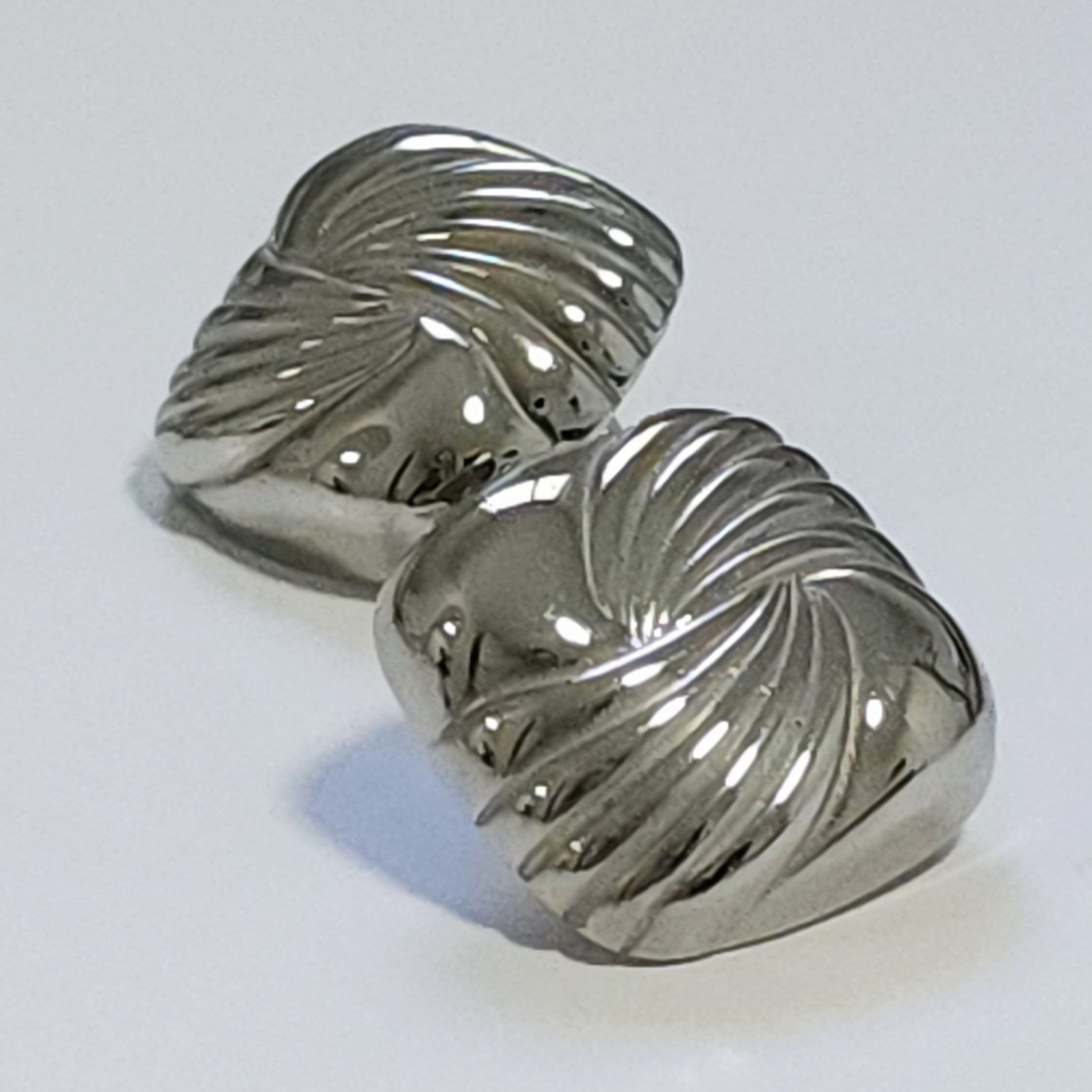 Pair of silver square statement earrings on a white background.