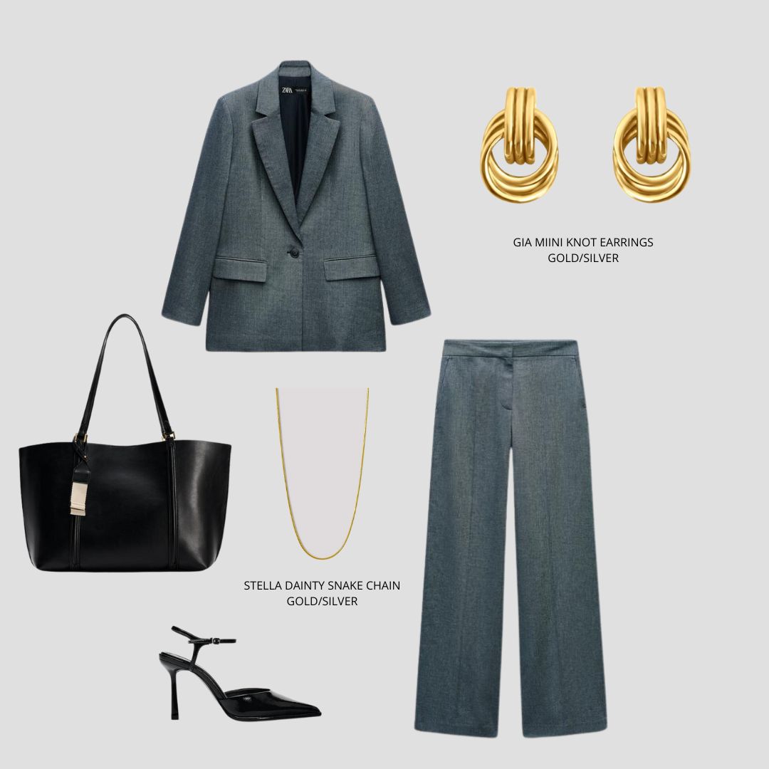 Grey blazer and pants, black tote bag, black heels and gold knot earrings on a light grey background.