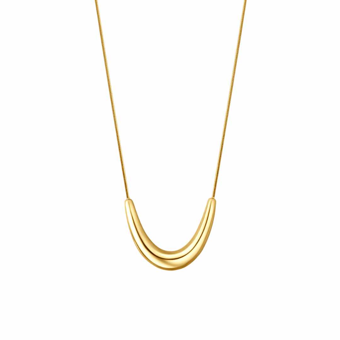A gold-colored pendant necklace with a bold pendant on a dainty snake chain.